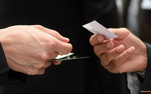 Close up of hands exchanging business cards