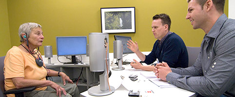 Conversation scene: two hearing aid acousticians talking to a client