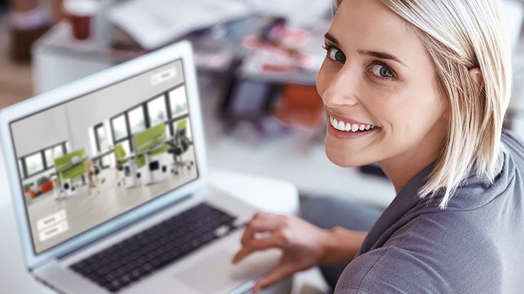 woman in front of a computer smiling into the camera
