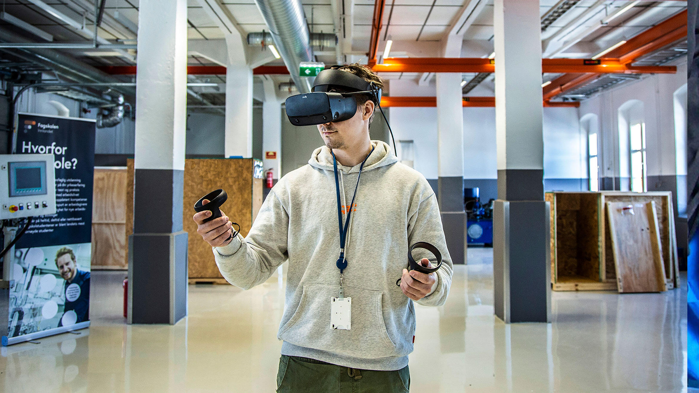 junger Mann mit VR-Brille in einer großen Halle