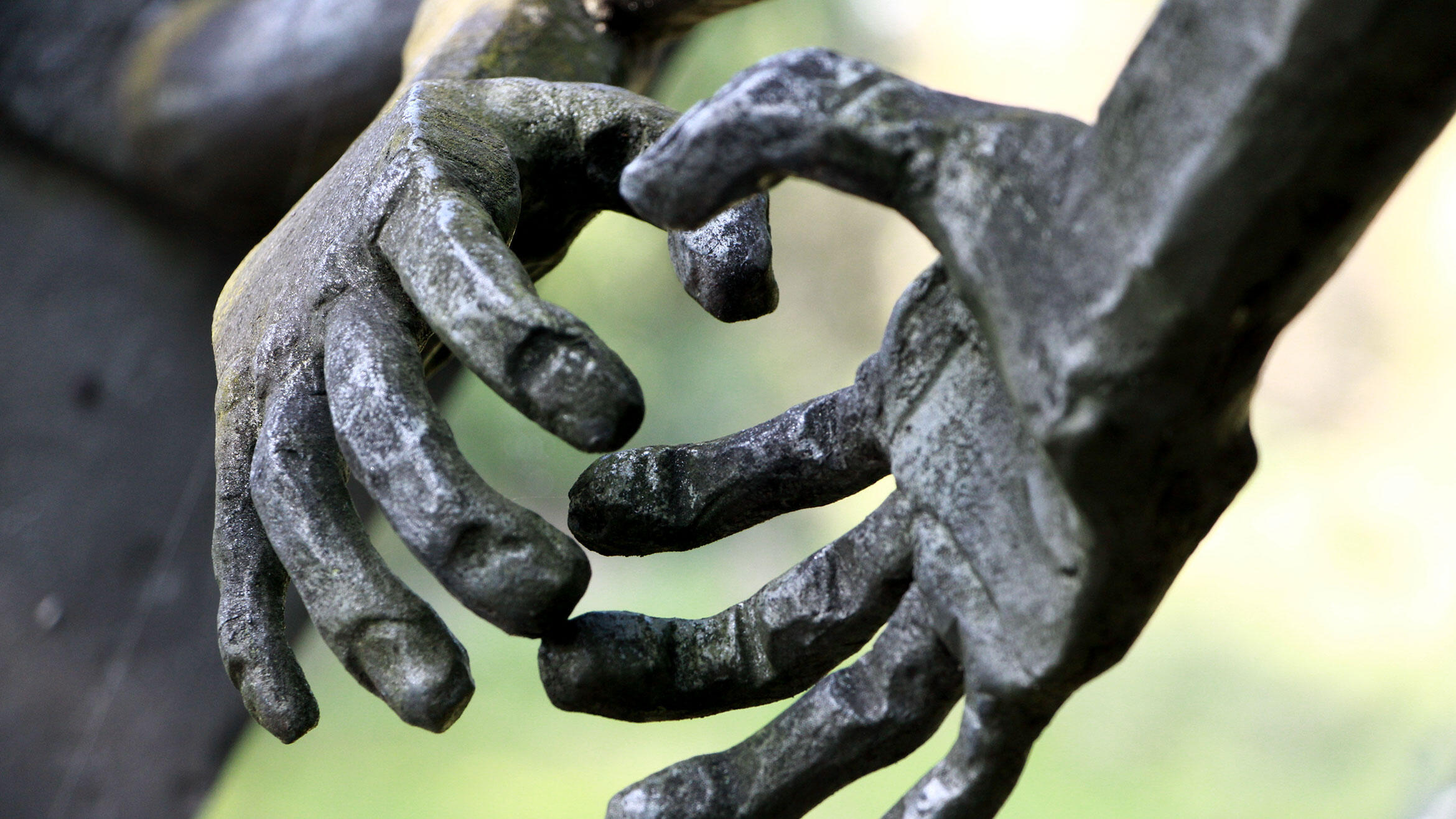 Detailansicht einer Skulptur: zwei Hände kommen zusammen