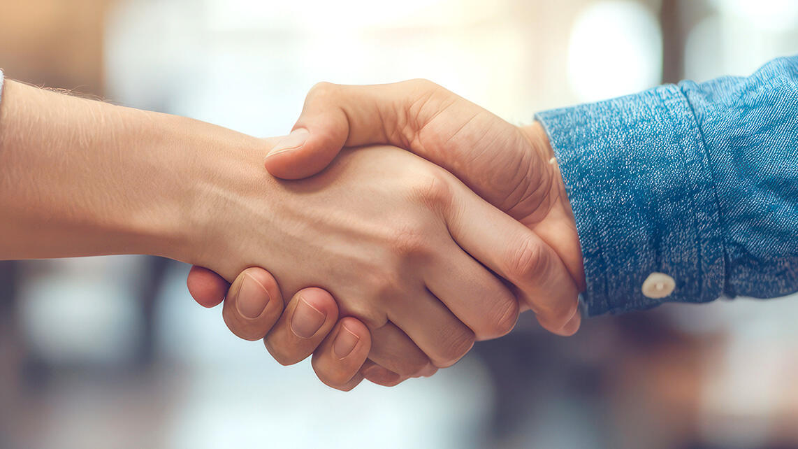 Mann und Frau schütteln sich die Hand