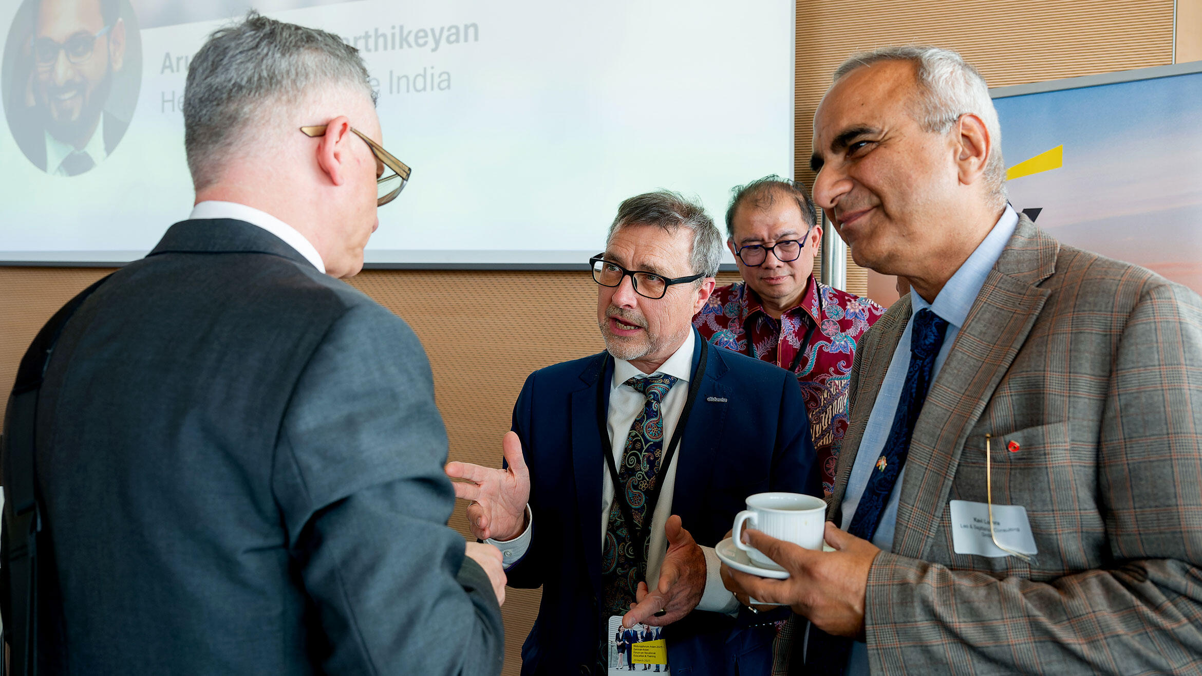 three men in a discussion