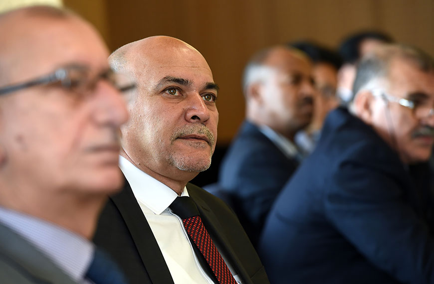 Close-up of several participants listening to a speaker
