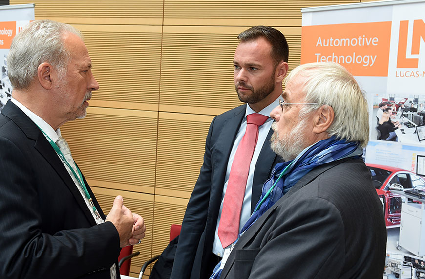 three men in conversation