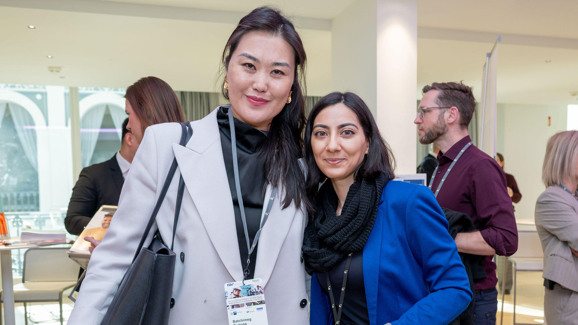 two women are smiling at the camera