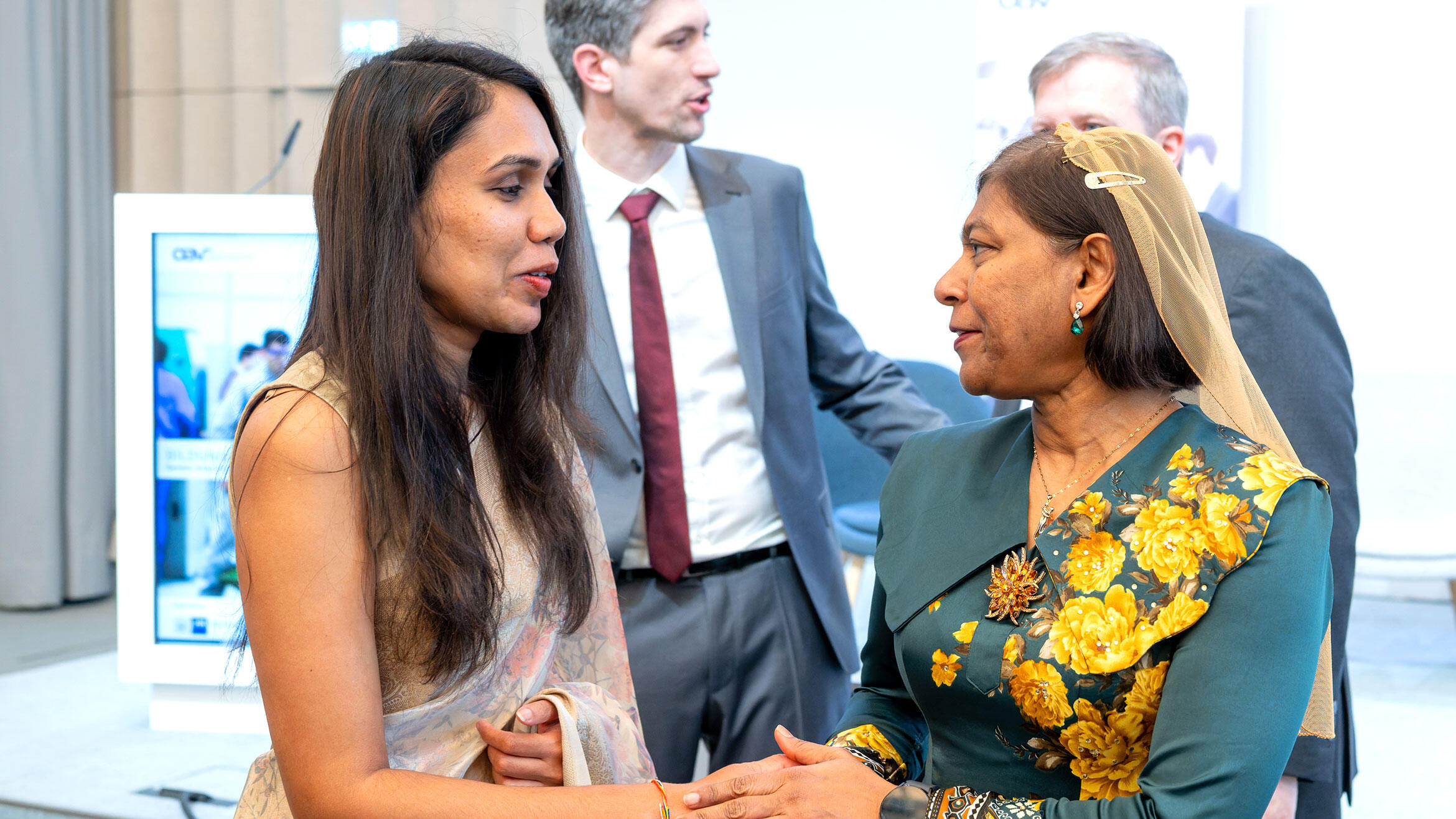 two women from Asian countries in discussion