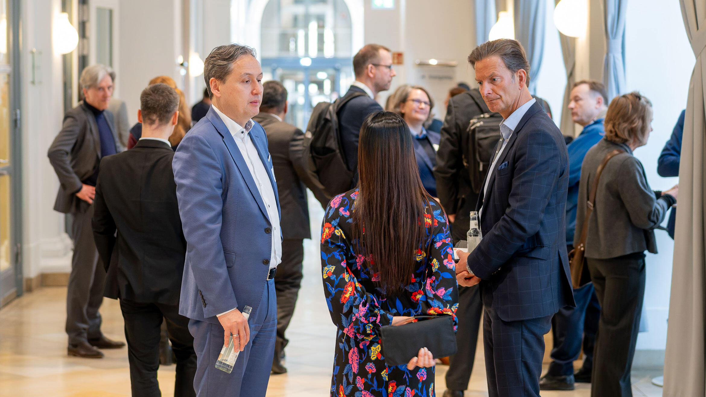 a few people standing in groups together