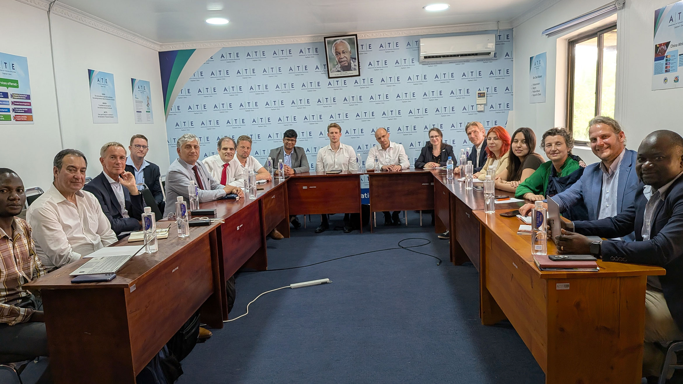 Delegation and host sit at a large U-shaped table