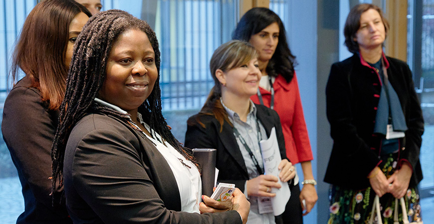 German and African women stand together