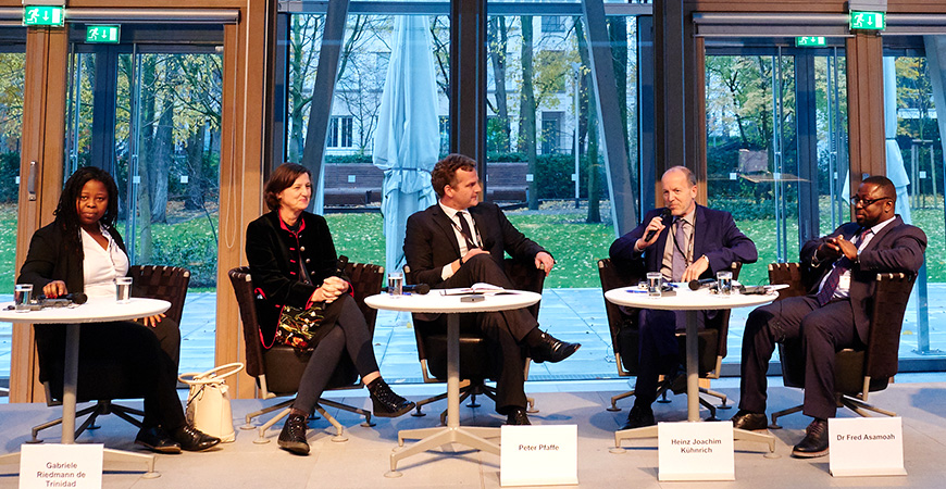 five female and male speakers on the podium