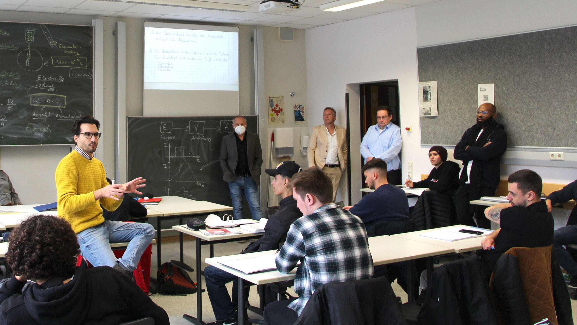 Trainer speaking to the delegation in a classroom