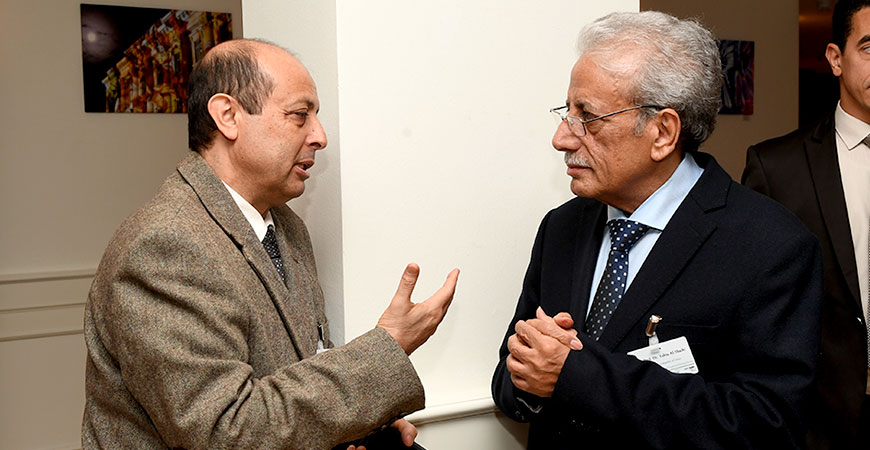two people standing together in discussion