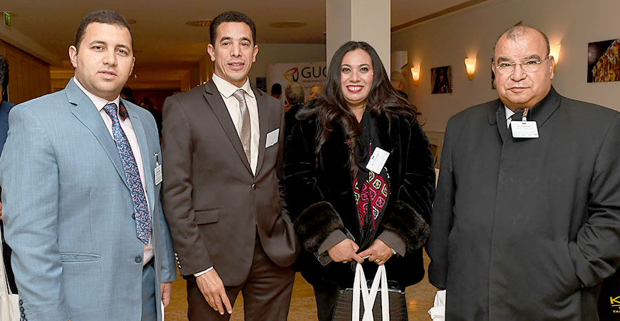 four people smiling into the camera