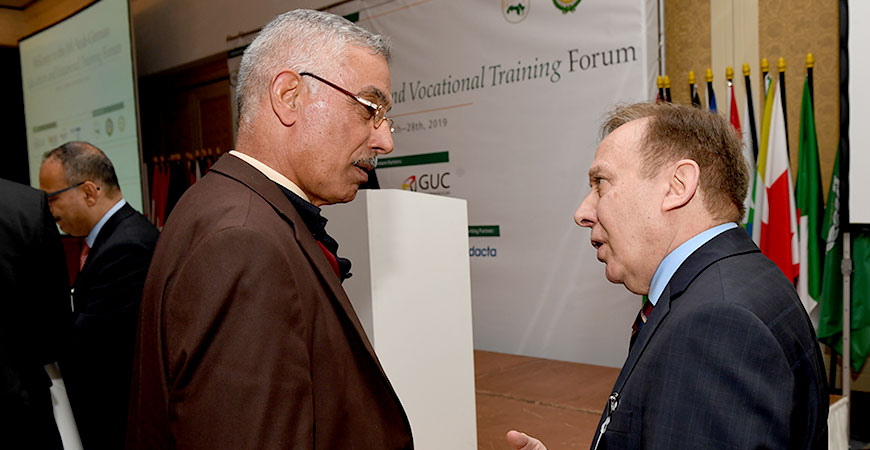 two people standing together in discussion