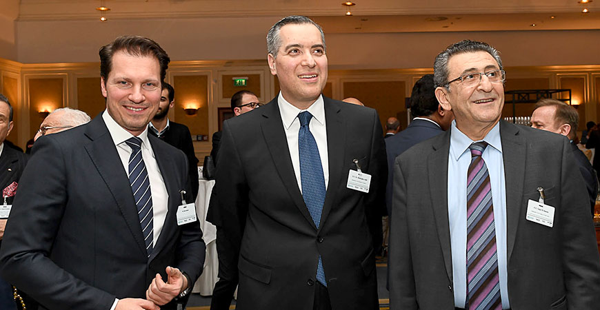 three people smiling into the camera