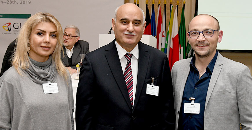 three people smiling into the camera