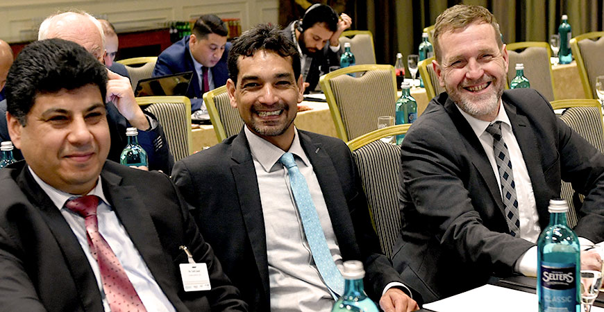 three attendants smiling into the camera