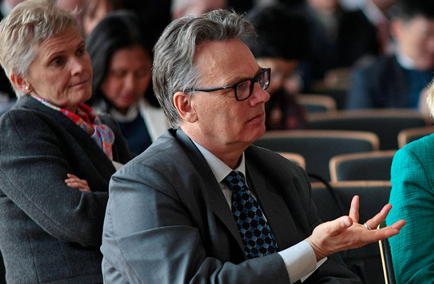participant asking a question to speakers on the podium