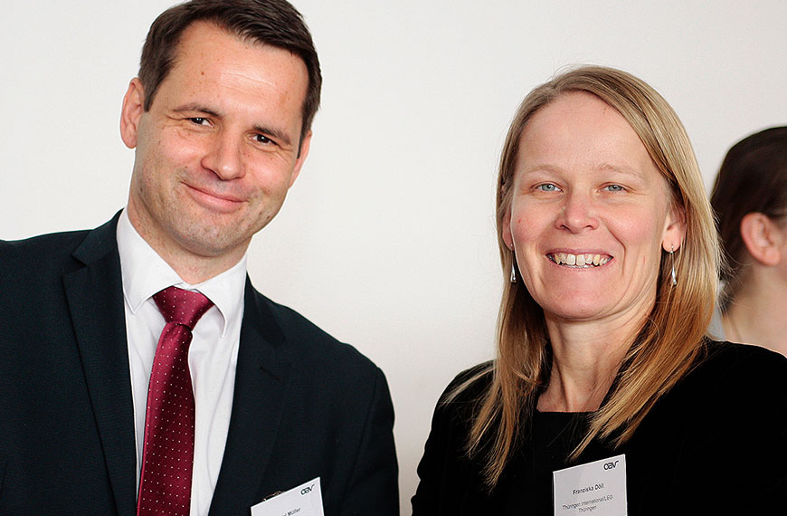 two people smile into the camera