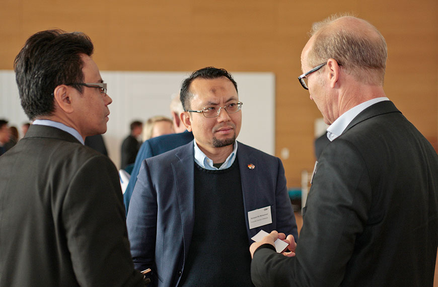 three men in a discussion