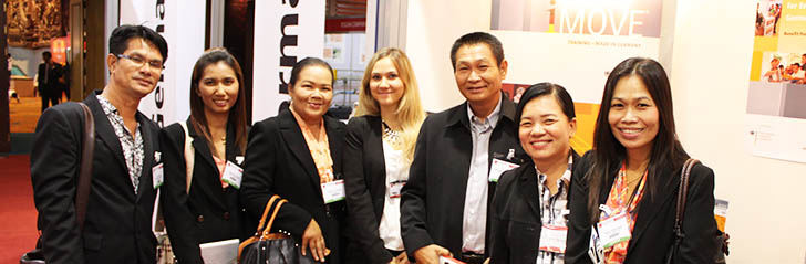group photo of Asian visitors at the iMOVE information stand