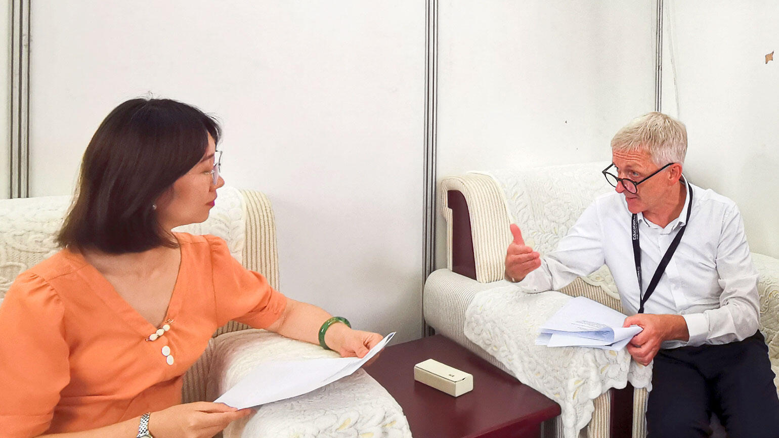 man and a woman sitting at a table and having a discussion