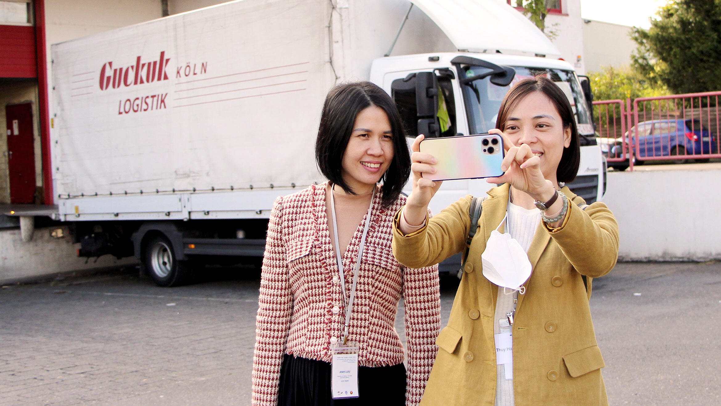 two women from Asia, one is taking a picture