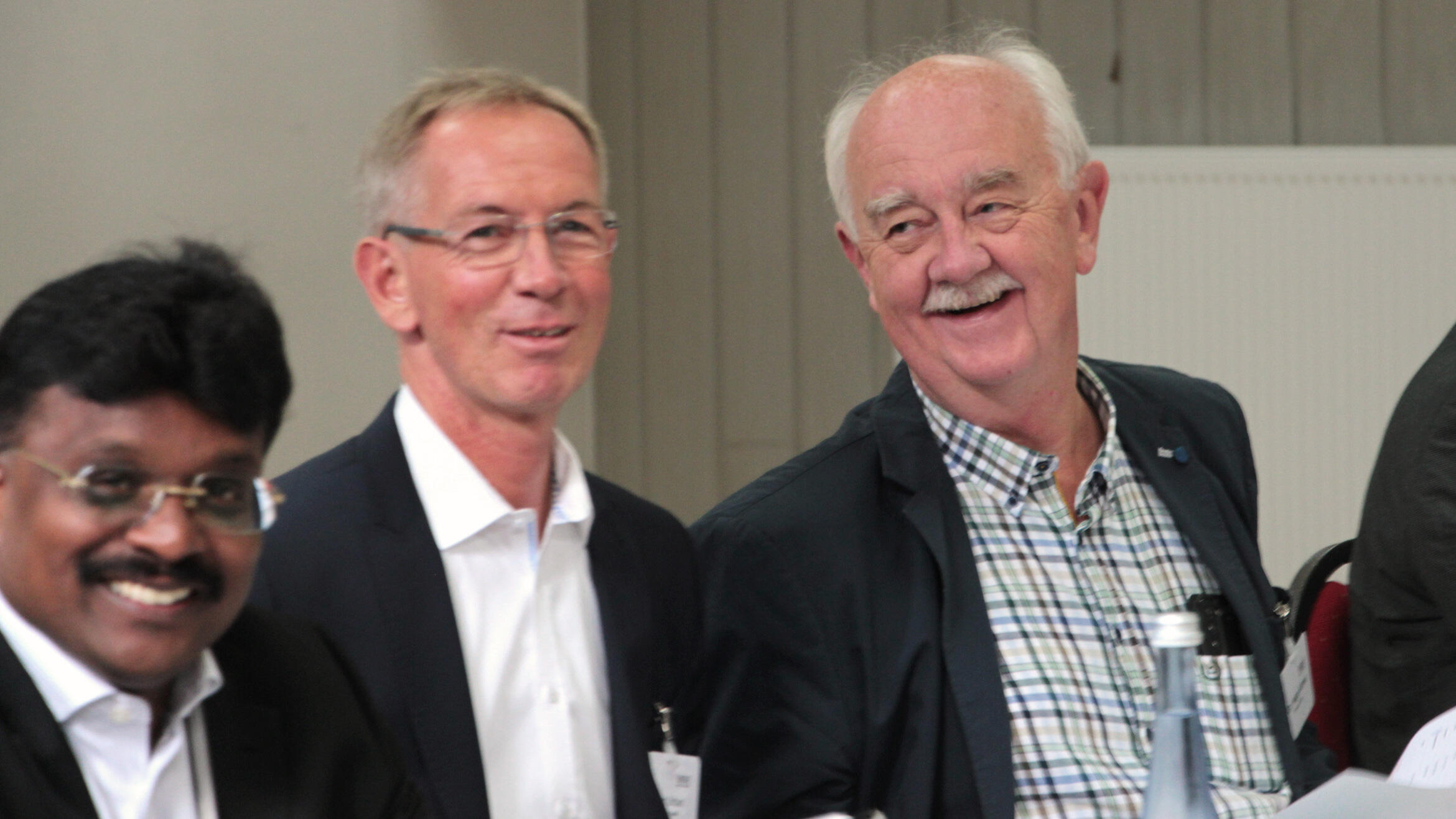 three men laughing into the camera