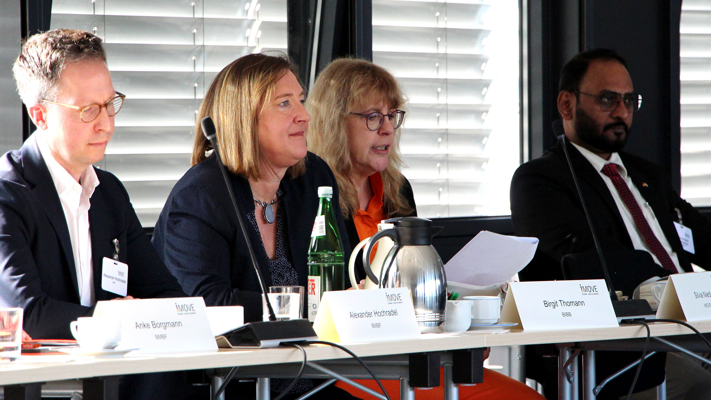 Row of seats with some participants at the first round table