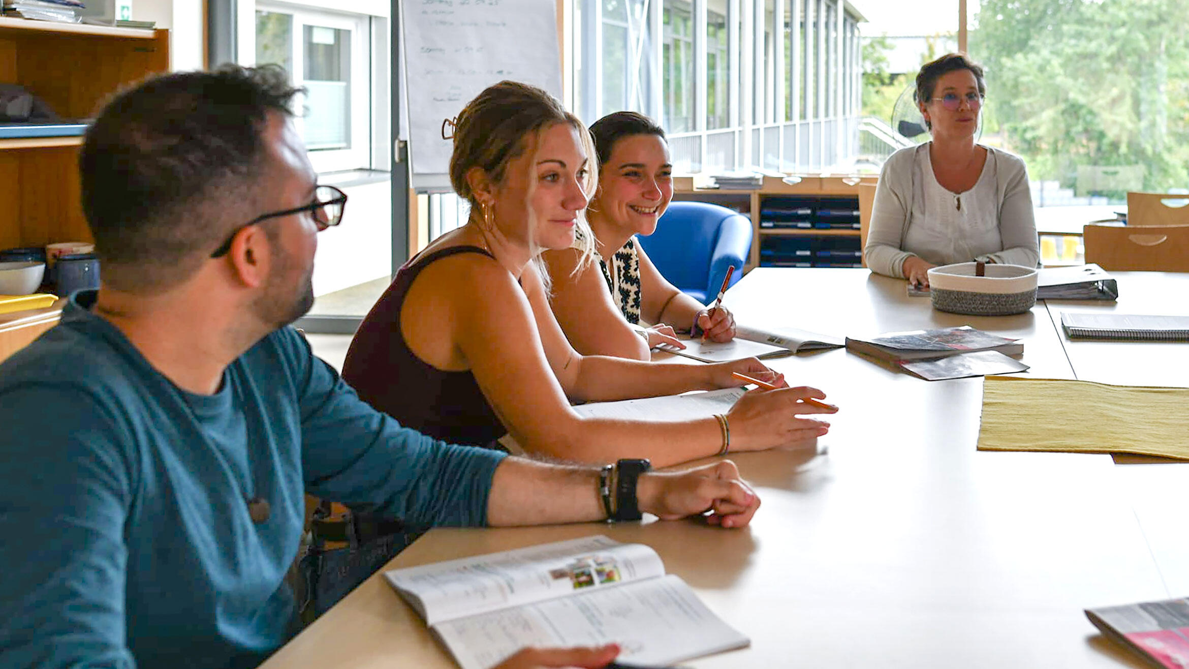 several men and women in a learning situation