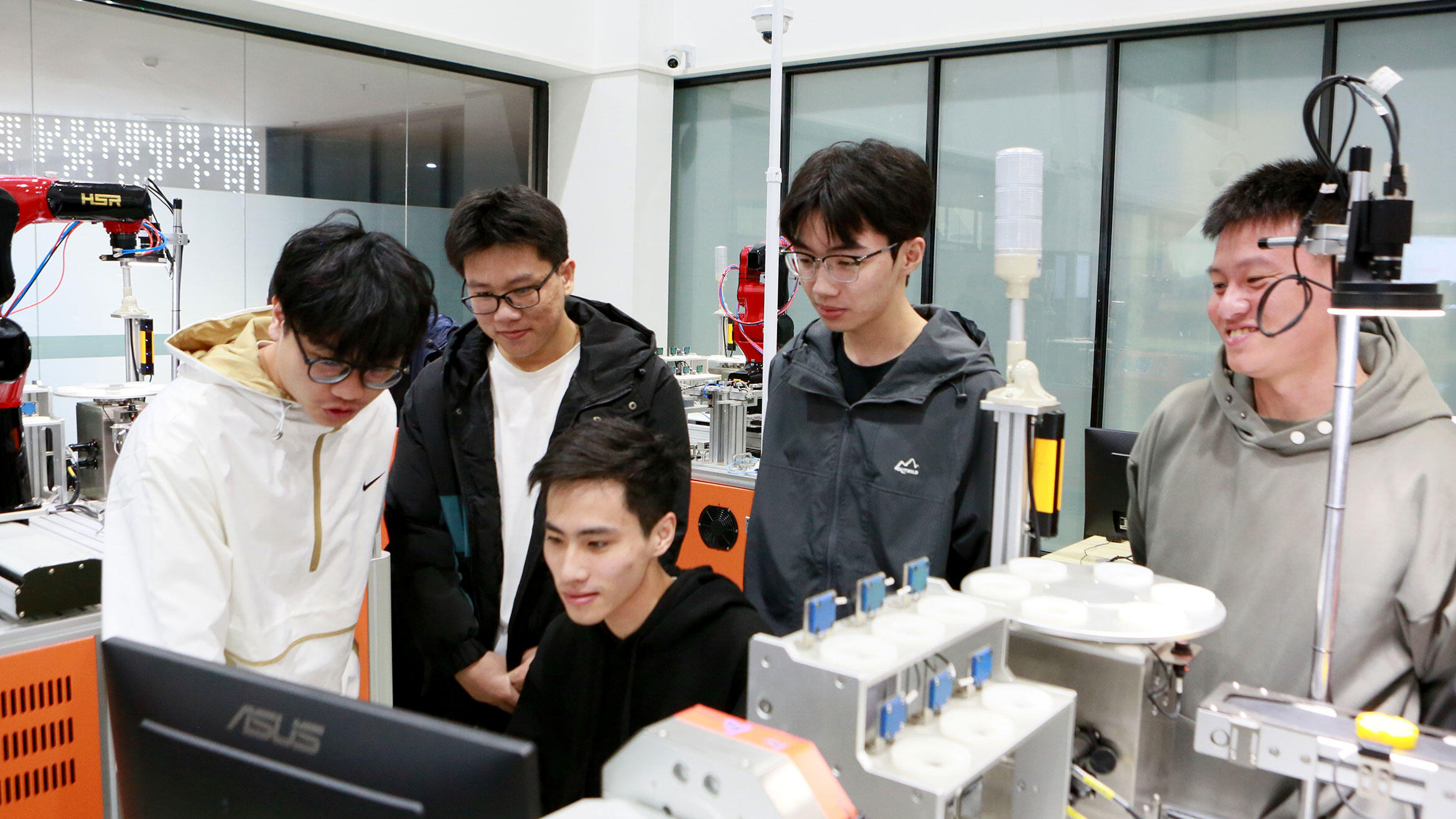 Chinese trainers in a teaching workshop look at a screen