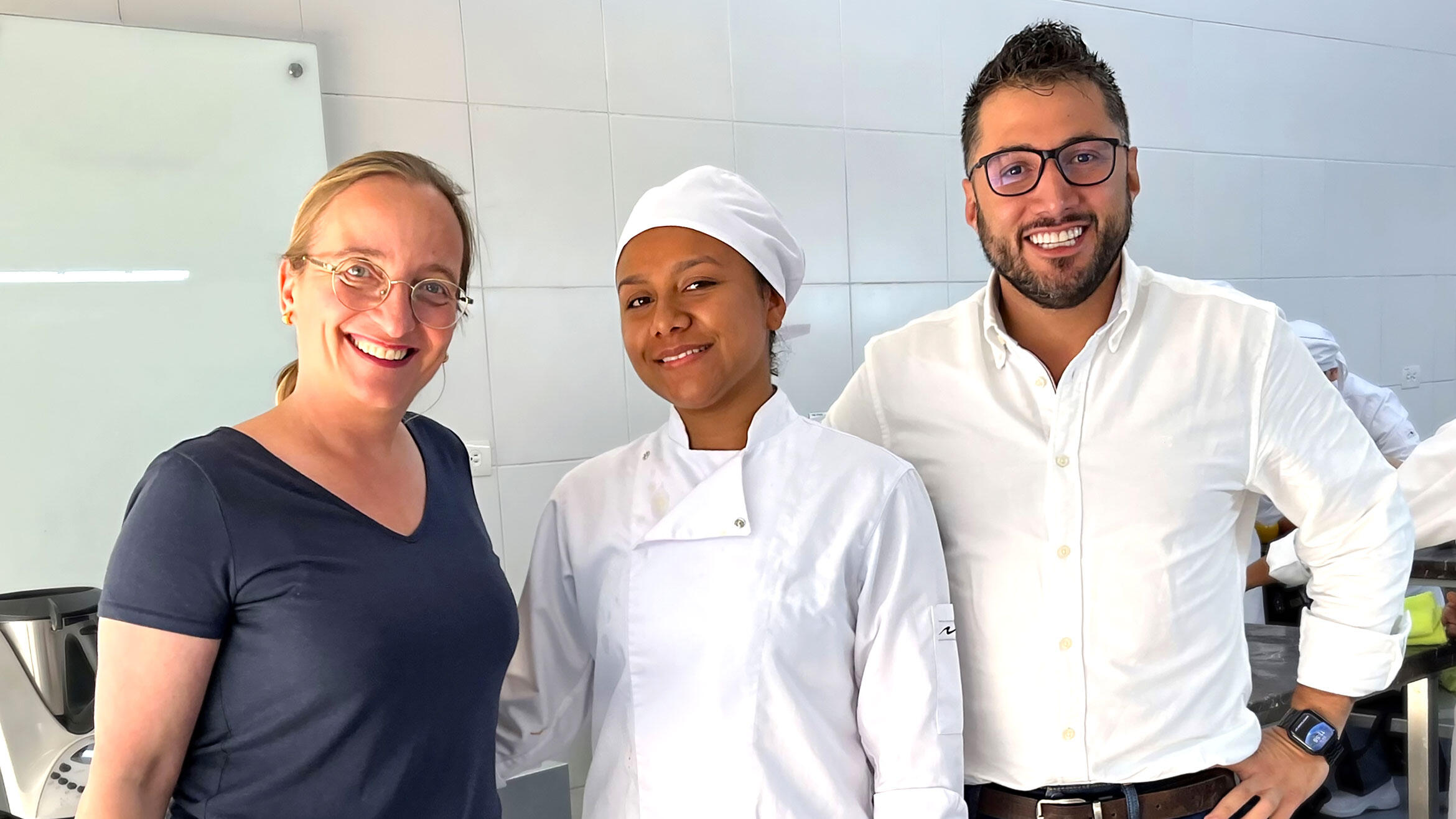 group picture with two women and one man smiling into the camera