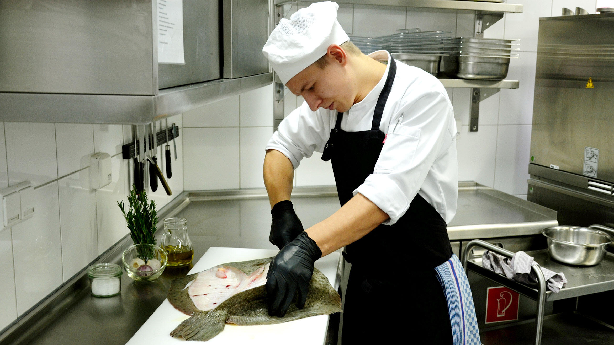 young man gutting a fish