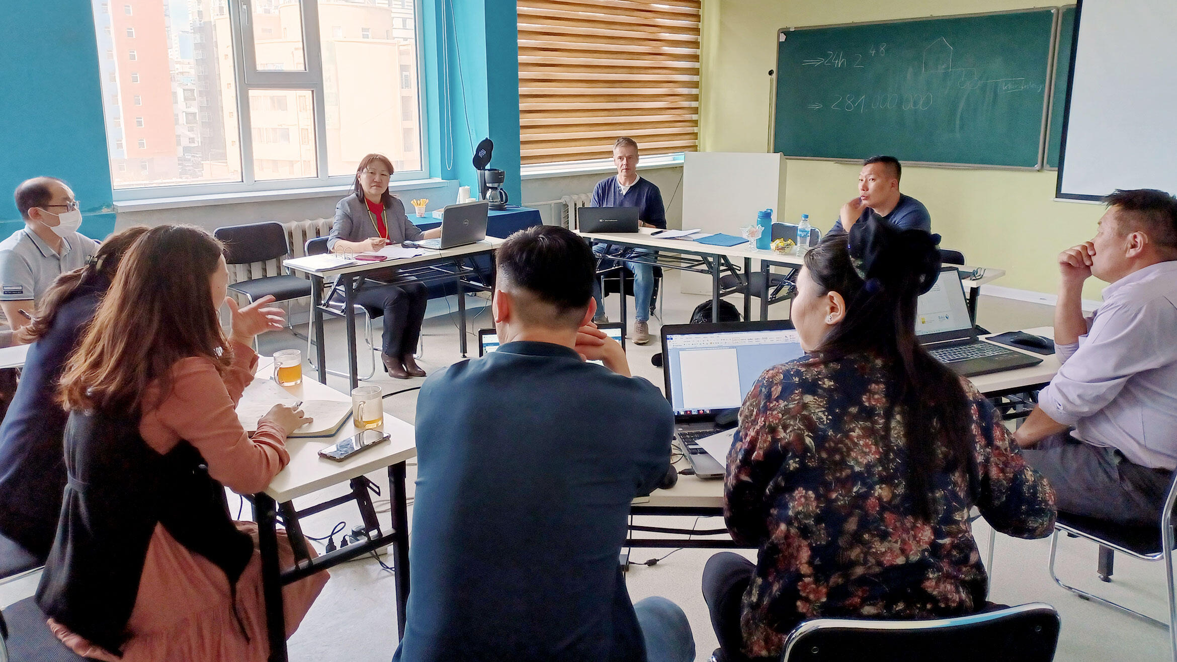 Group of nine people sitting together in a training situation