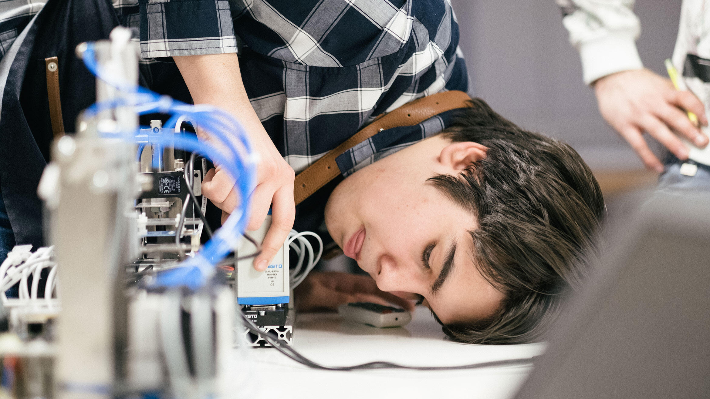 Close-up: young Serb checks a test circuit