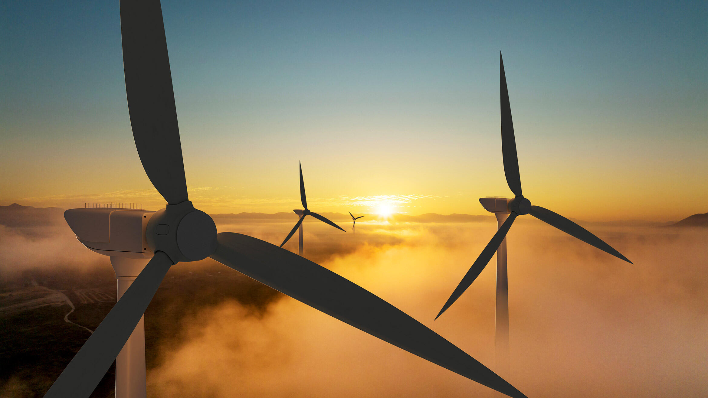 The silhouettes of some wind turbines at sunset