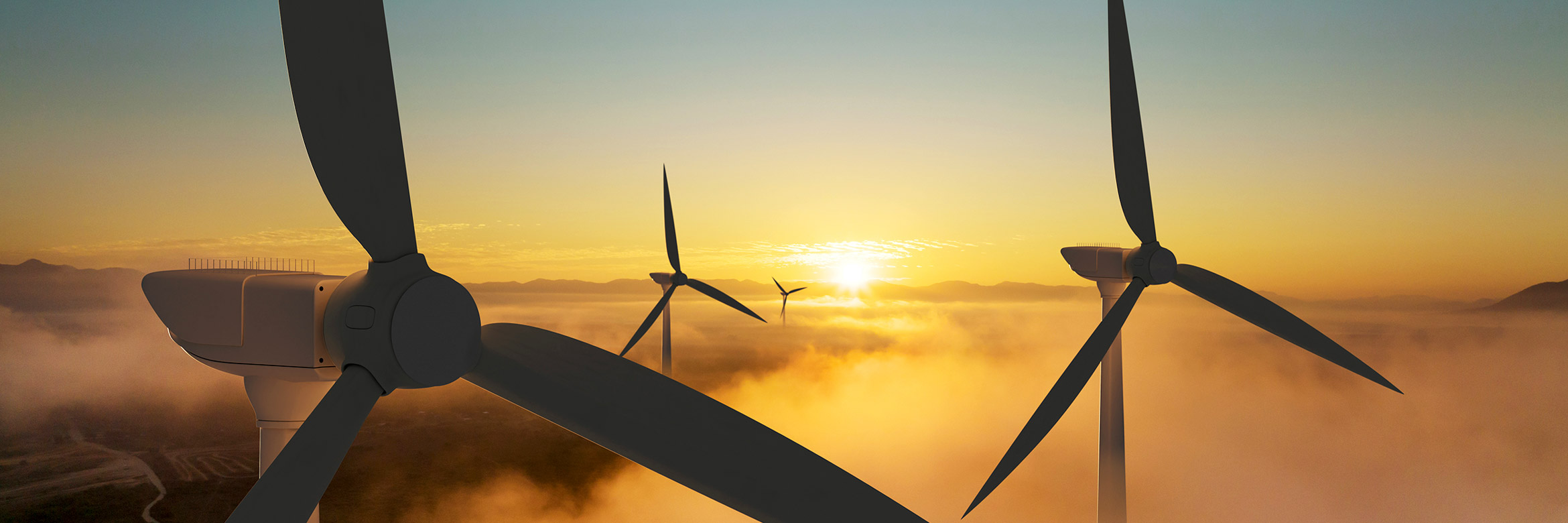 The silhouettes of some wind turbines at sunset