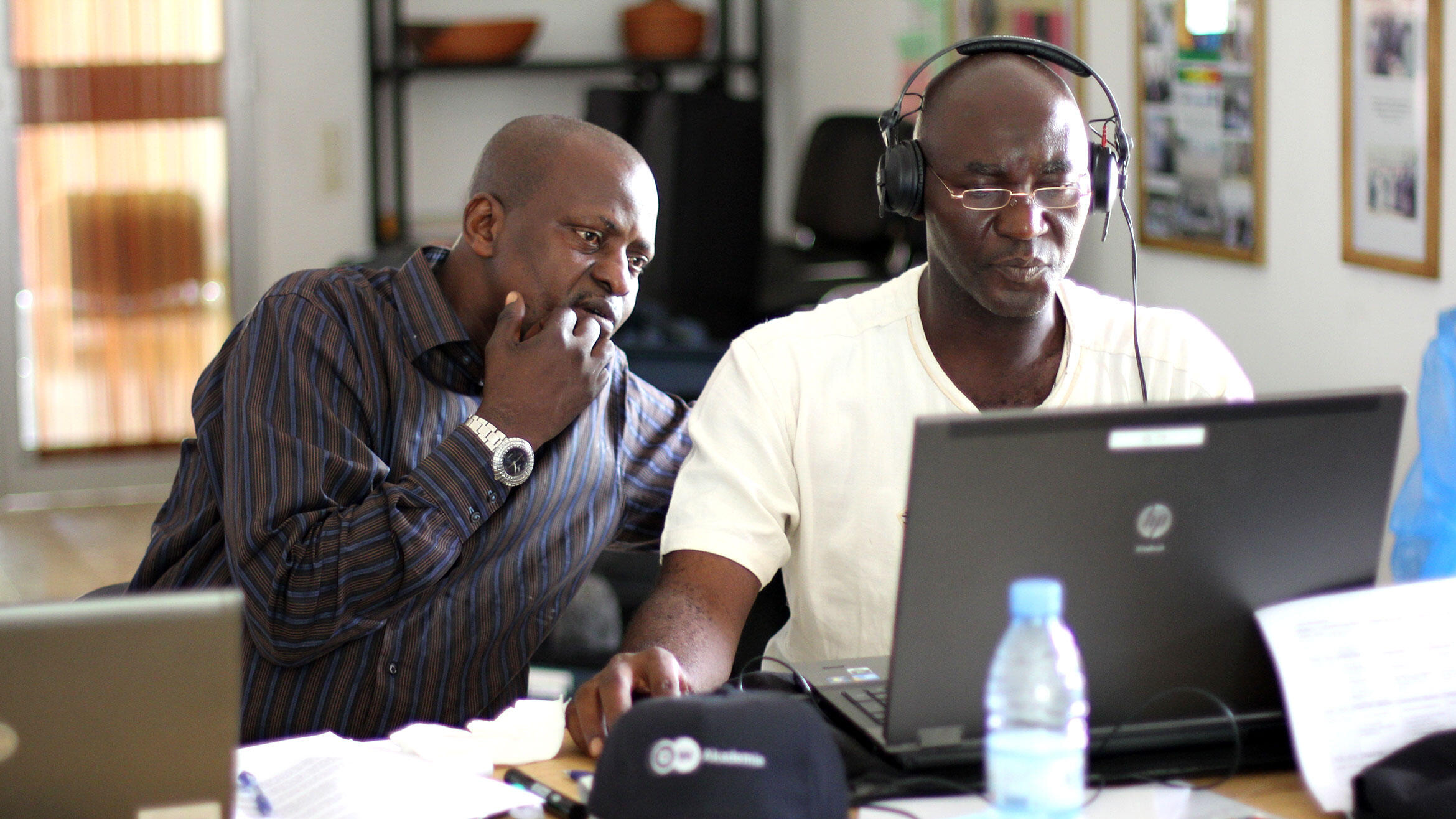 two africans are working on the computer