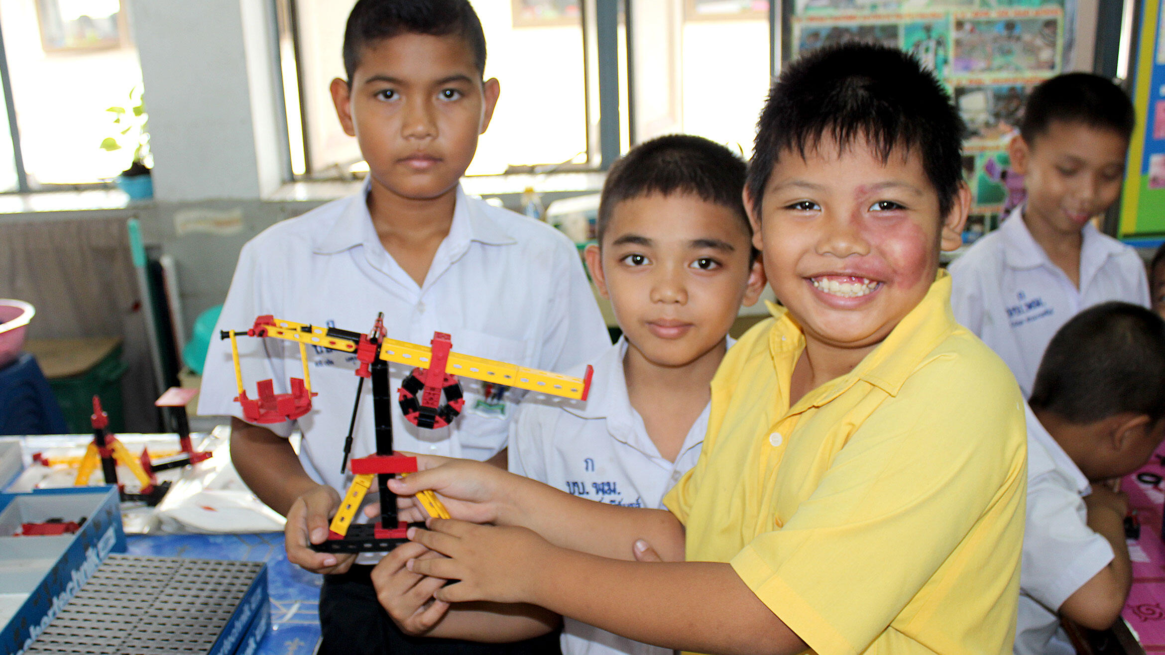 Asian kids play with technical game pieces