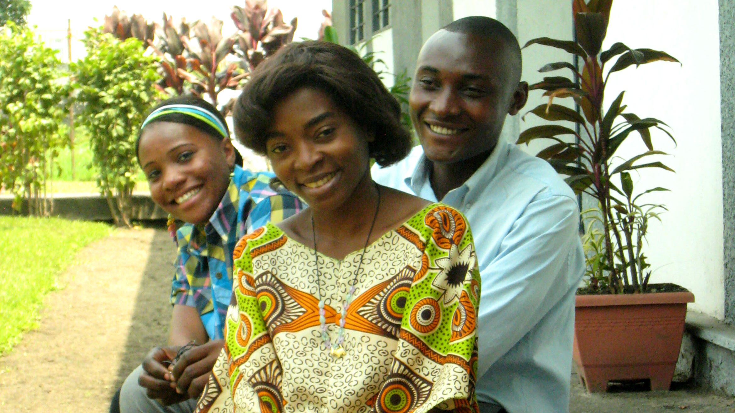 three African students smiling in the camera