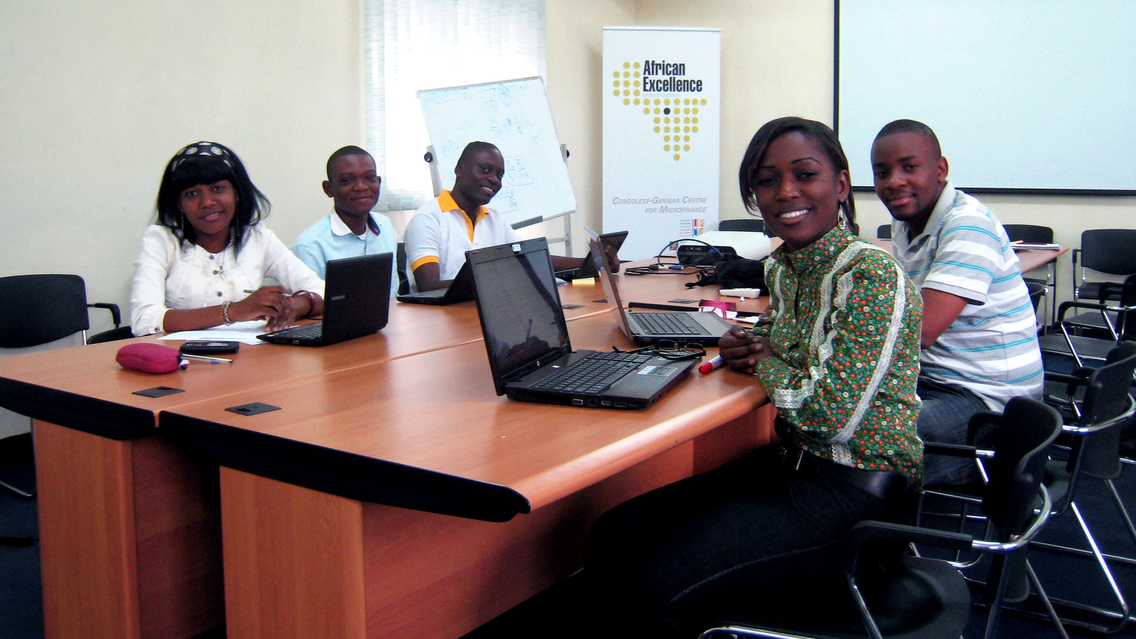 five young Africans in a classroom in a working group