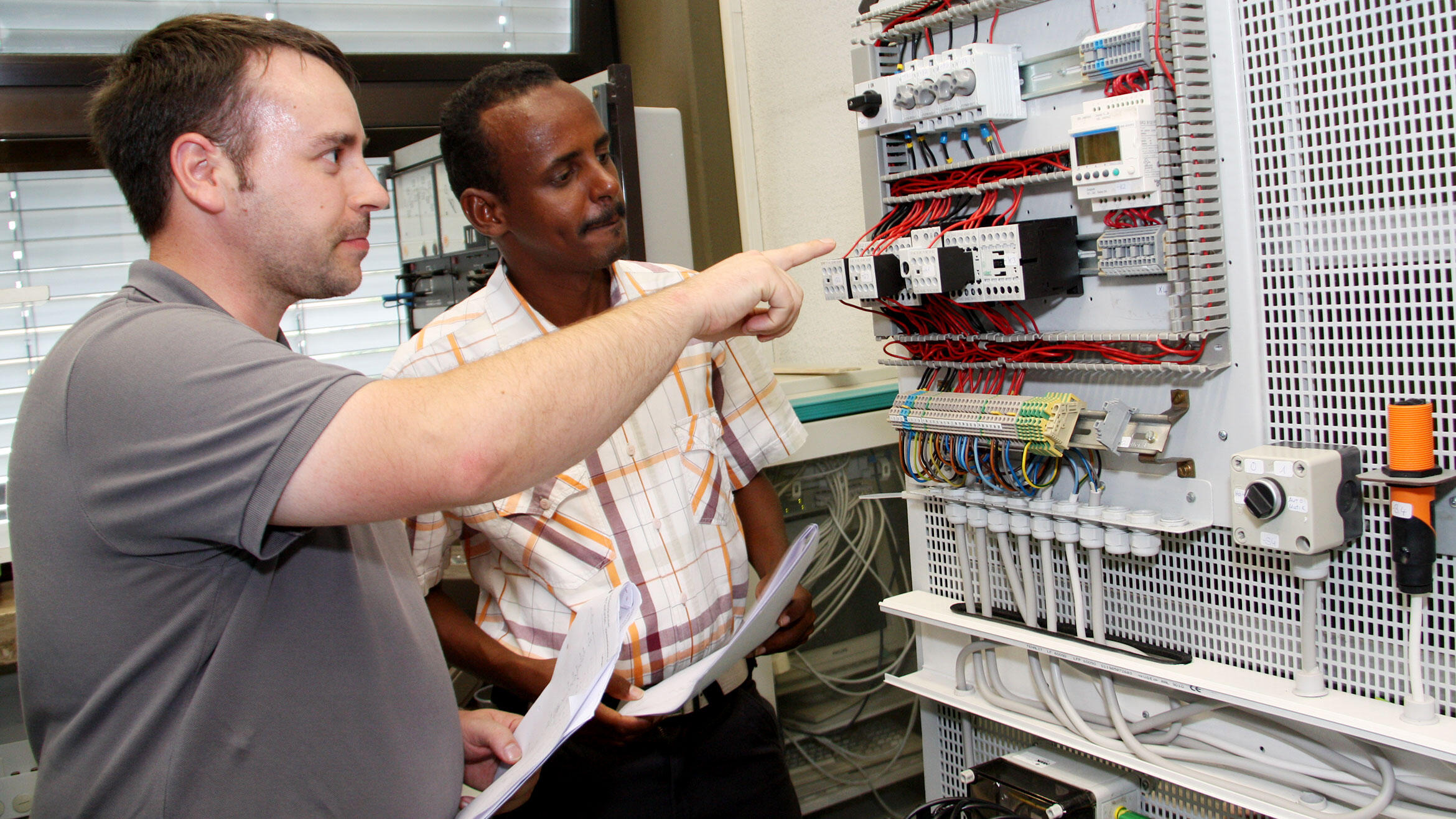 Trainer explains something on switchboard