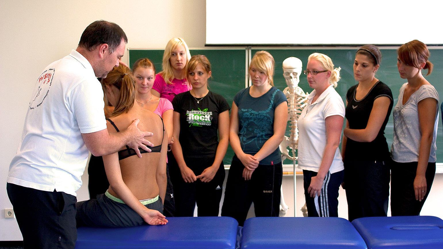 group of women observe a physiotherapist demonstrating a treatment