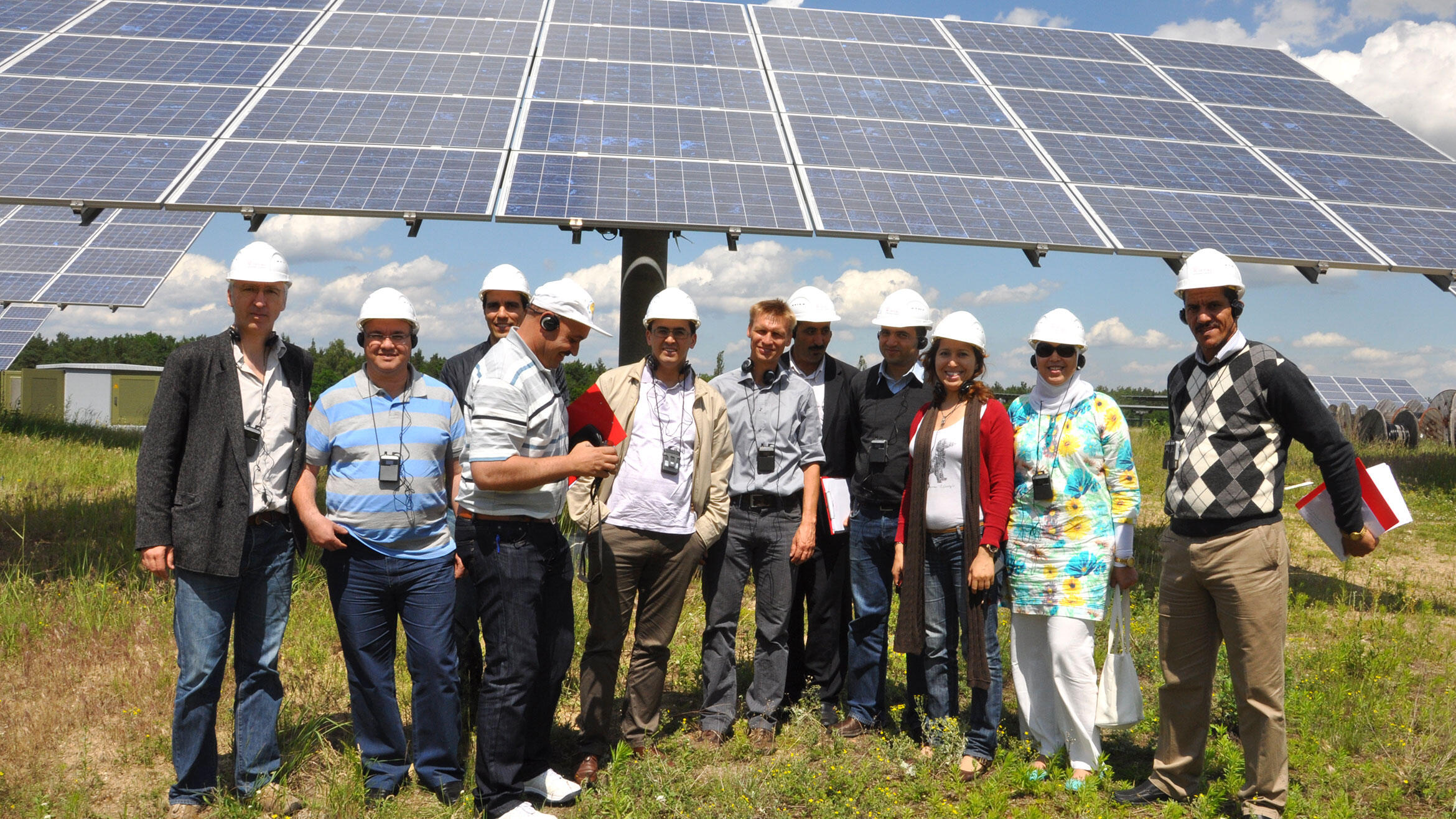 group picture in front of solar cells