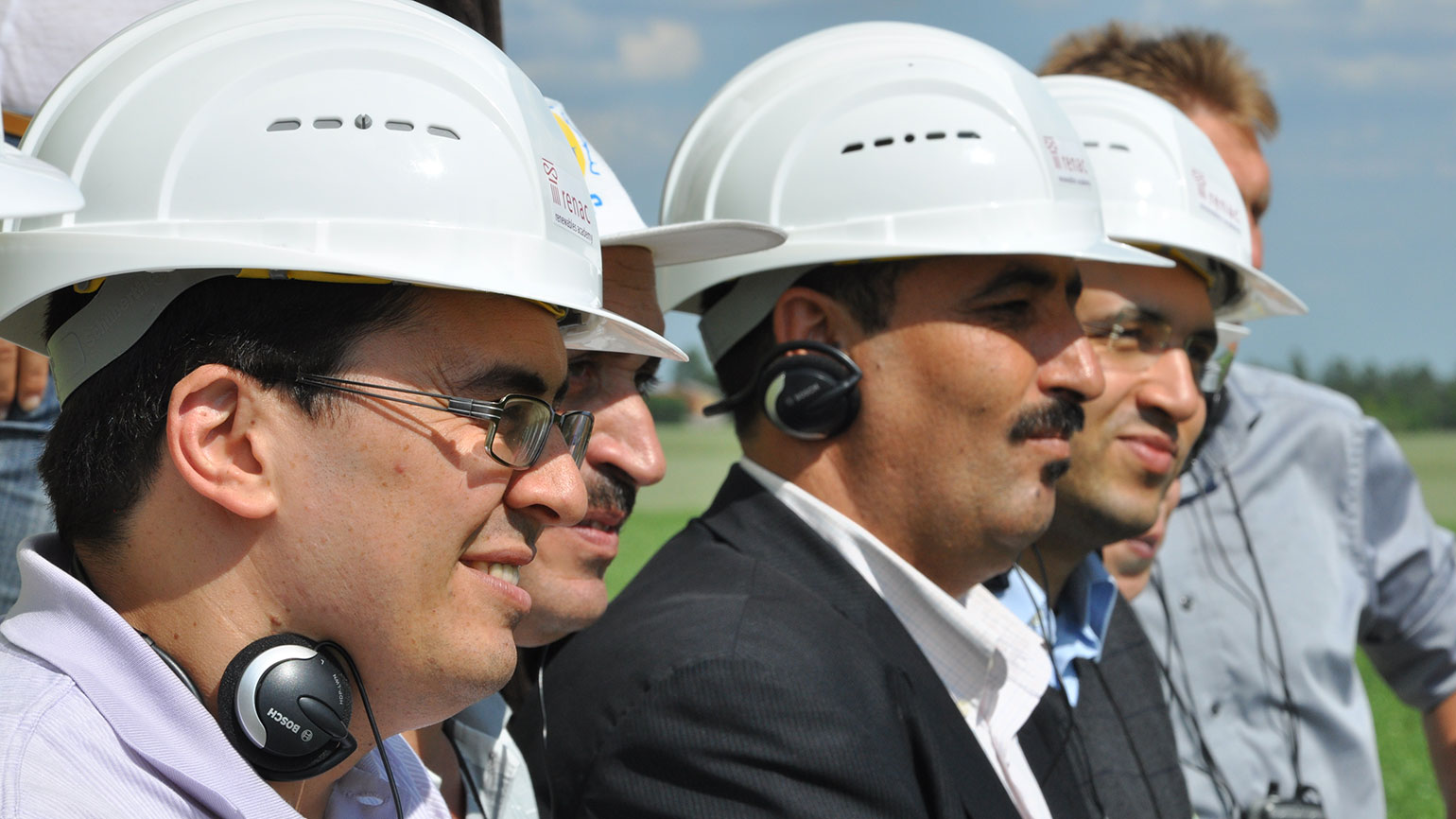 close up of some people with safety helmets standing in a row