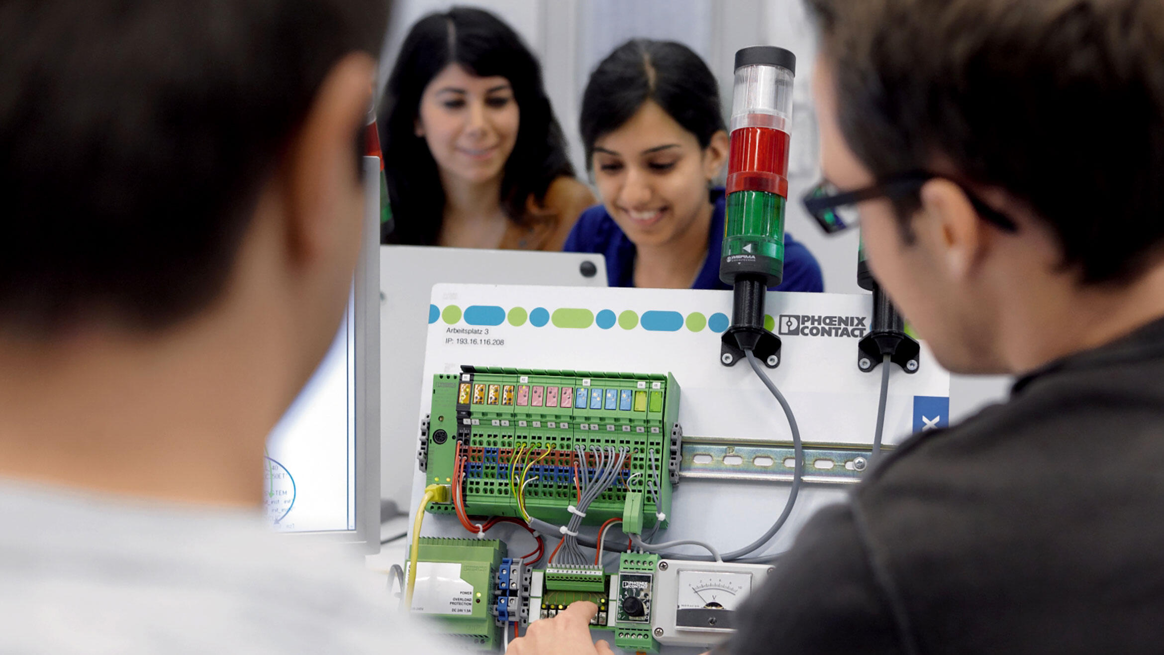 electronical equipment with few people standing around