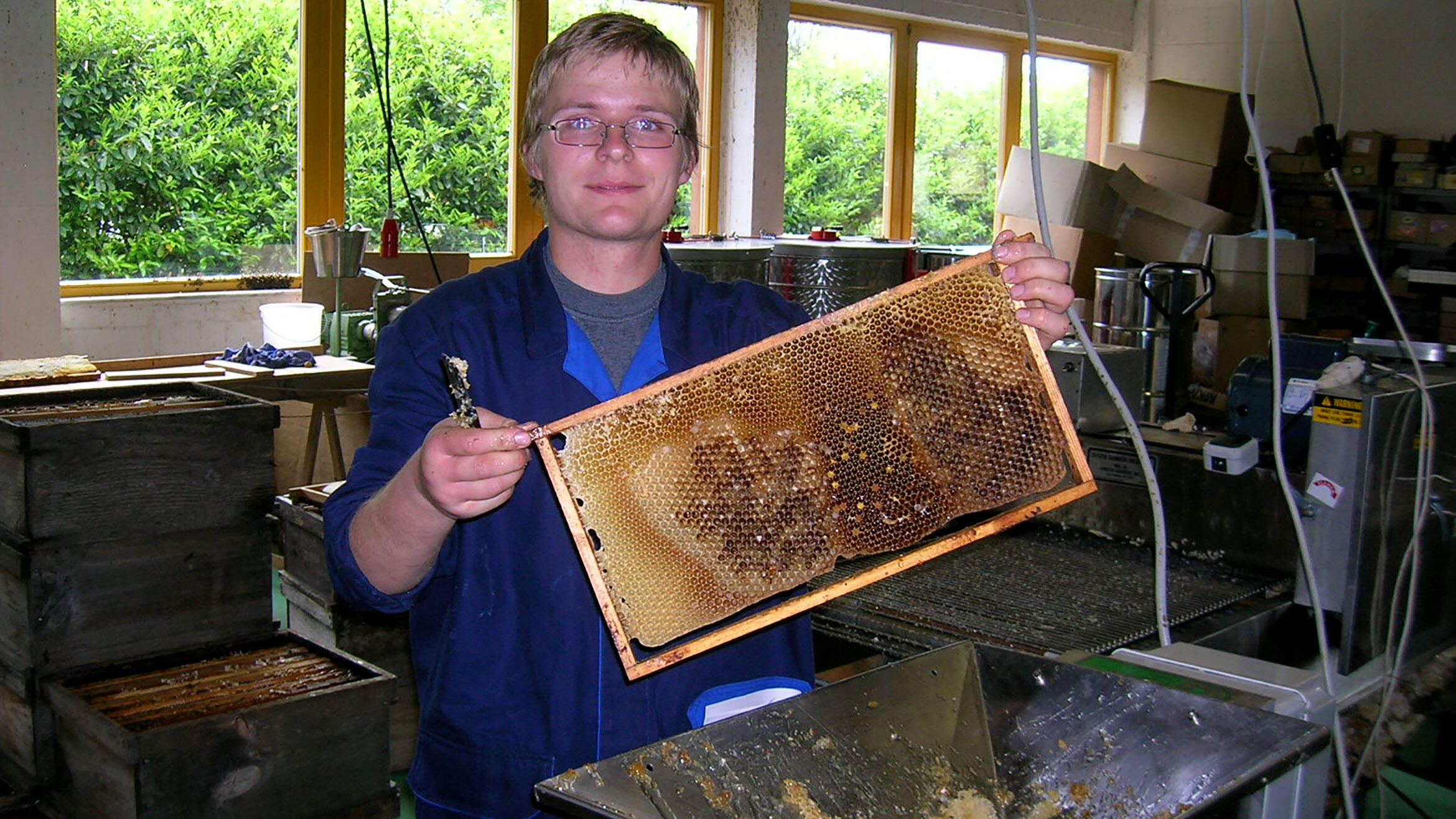 man shows filled honeycomb