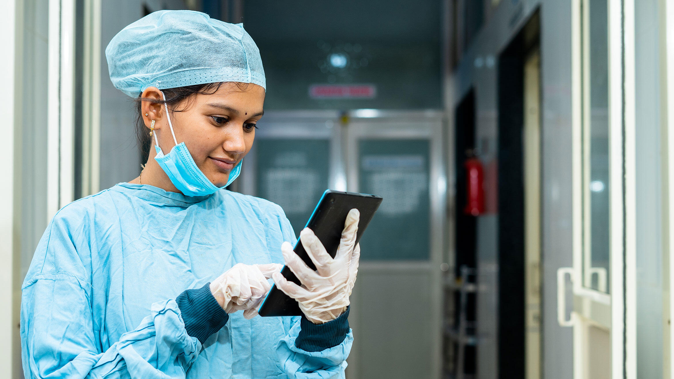 woman in OP clothes taps on a tablet