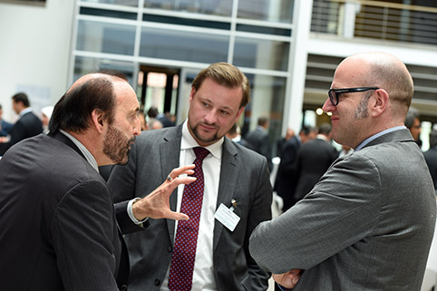 close-up of a conversation amongst three participants during a break